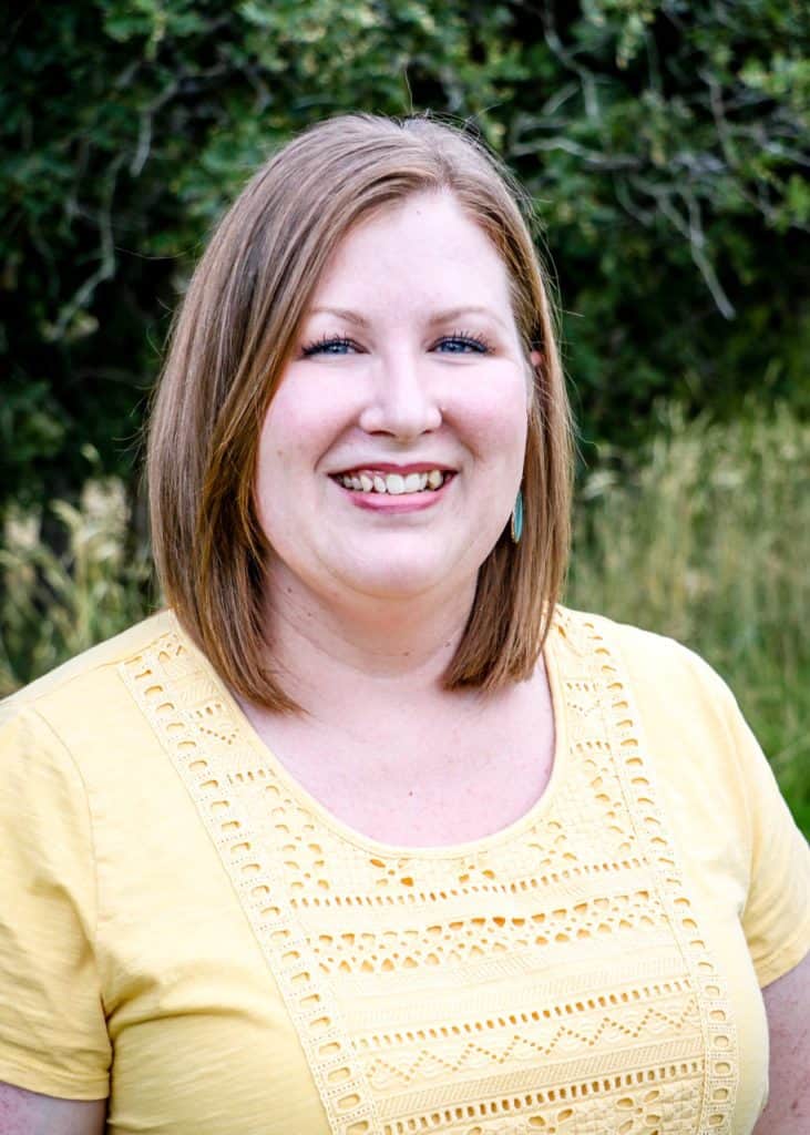 Caucasian woman in her early 40s. Straight, shoulder length bob, wearing a pale yellow t-shirt.