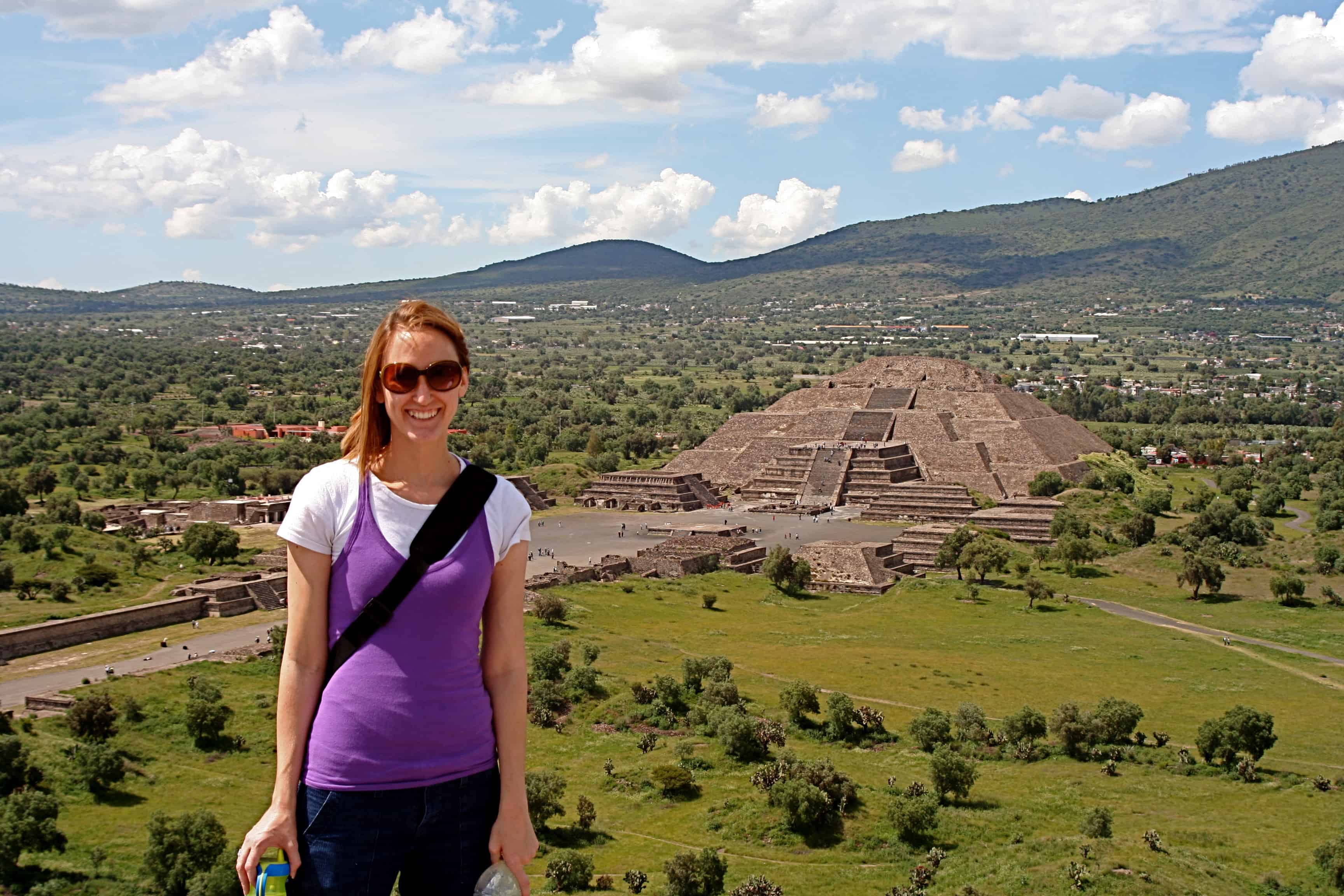 30's aged white woman in Mexico with a pyramid in the background.