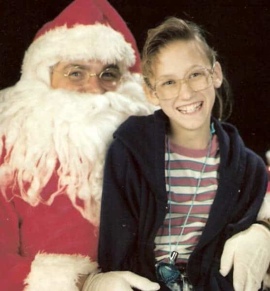Young girl, about 12, sitting on Santa's lap. Circa 1990's.