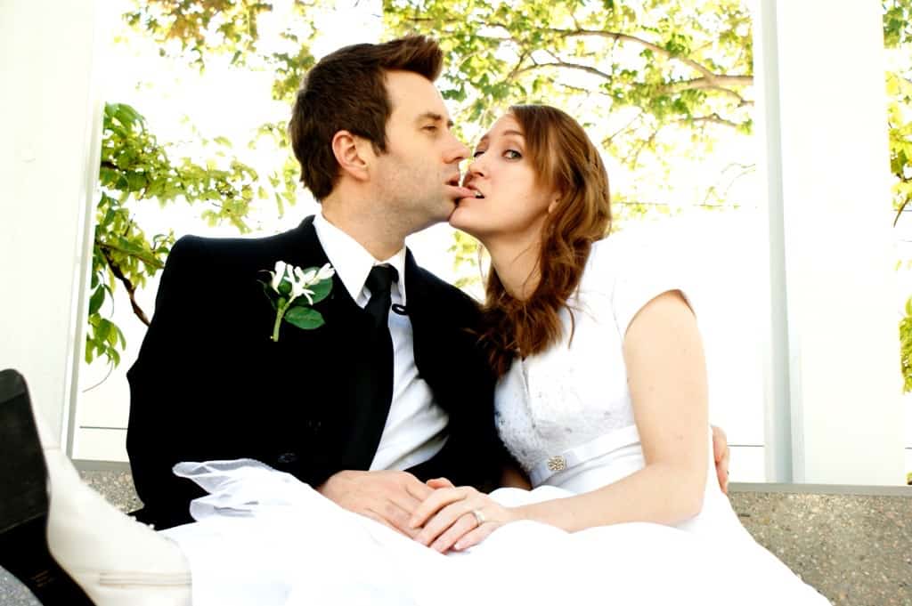 Couple sitting together in wedding photo.