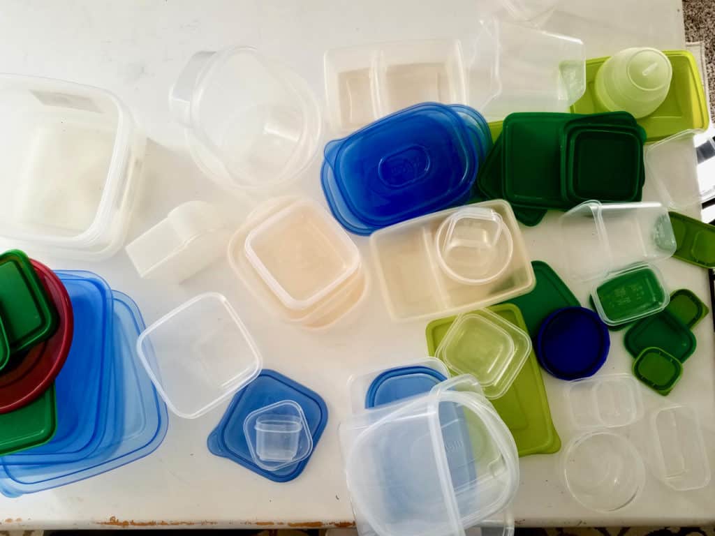 Is your tupperware storage a hot mess? How does it get unorganized so quickly?  Keep reading to find 4 simple steps to get it back on track in less than 20 mins! Tupperware Organization has never been so easy! | We Three Shanes