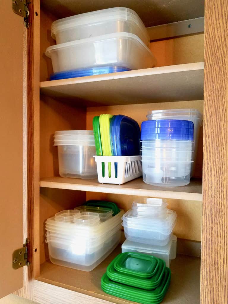 Is your tupperware storage a hot mess? How does it get unorganized so quickly?  Keep reading to find 4 simple steps to get it back on track in less than 20 mins! Tupperware Organization has never been so easy! | We Three Shanes