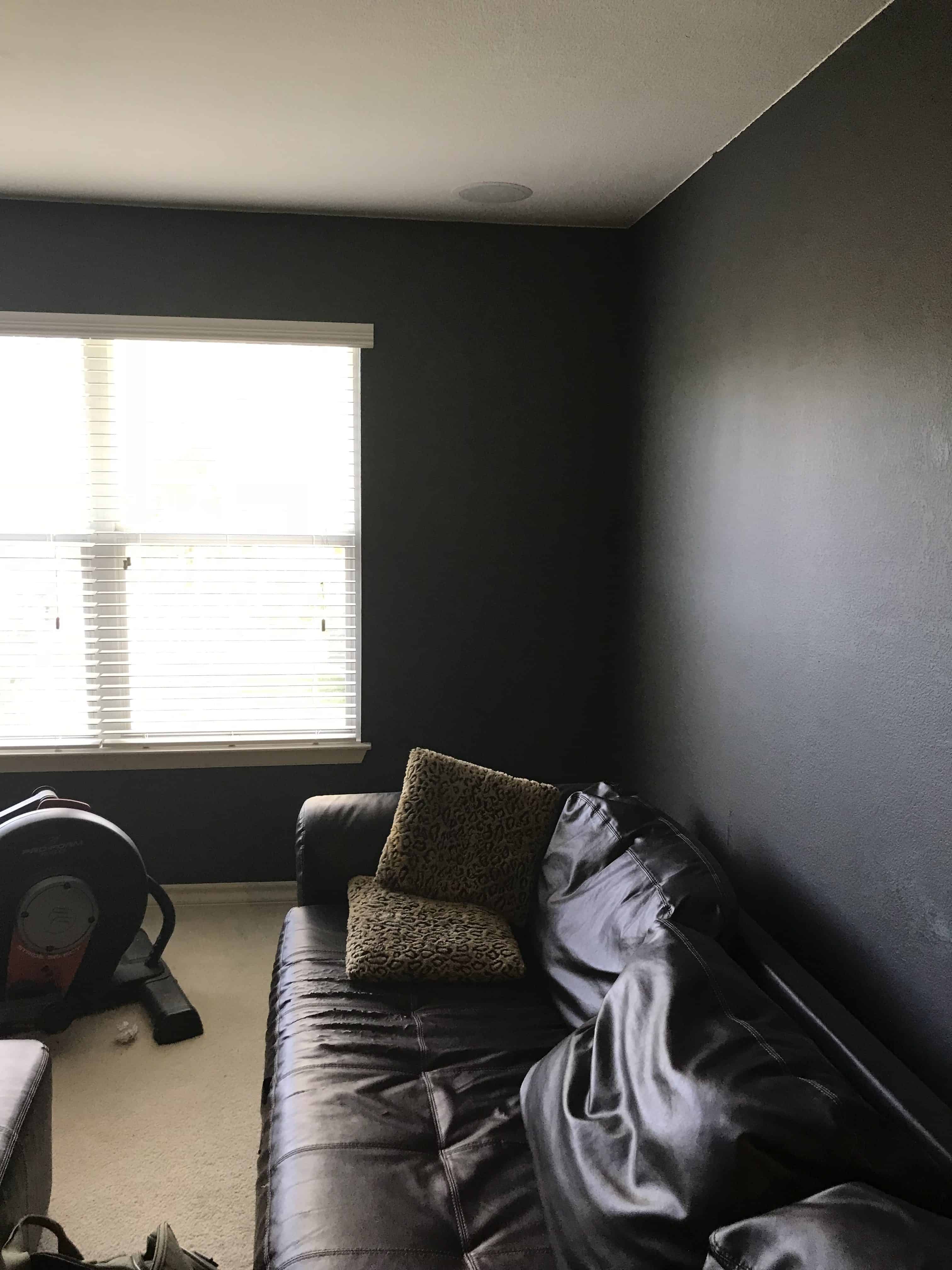 Photo of a "selfie corner". A wall with a big window on one side that is close to a corner. Then a blank wall on the other.