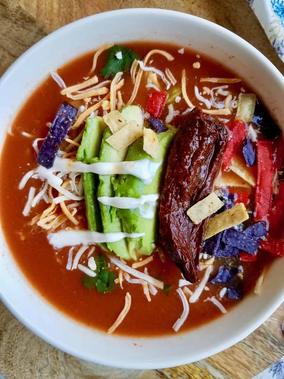 Chipotle Tortilla Soup is simple to make, easy to customize, and bursting with smokey chipotle flavor. It's a family favorite that is made year round, even in the hot summer months, because we can't go with out it. It is by far the BEST tortilla soup! You have to try it out. I absolutely promise you won't regret it! | We Three Shanes