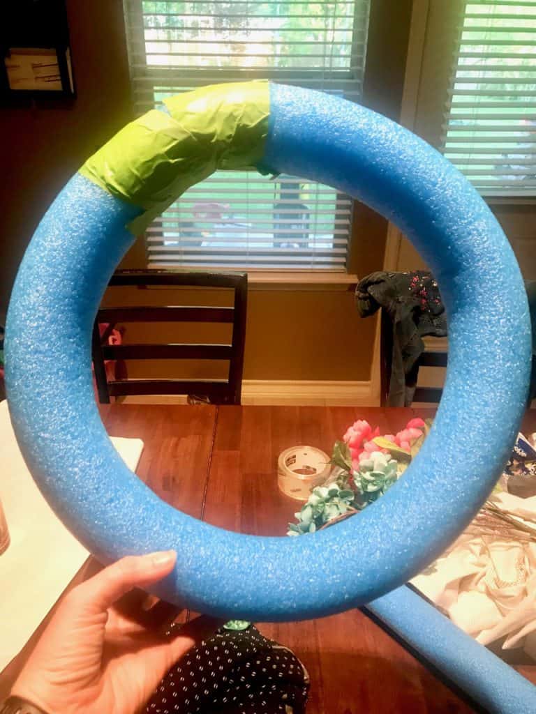 pool noodle tapped end to end to turn it into a wreath form.