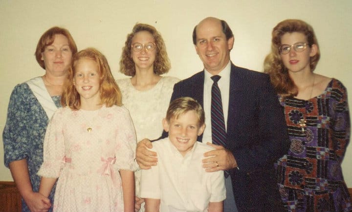 Old family photo from the early 90s. Mom & dad with 4 siblings- three girls from tween to teen and one preteen boy.