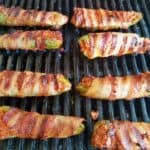 Looking for an easy appetizer recipe for your next barbecue? Stuffed jalapeno poppers are a must! Fresh jalapenos are filled with chorizo and cheese then wrapped with bacon and grilled to crispy perfection. These poppers are seriously addicting, making them a summertime cookout crowd pleaser. | We Three Shanes