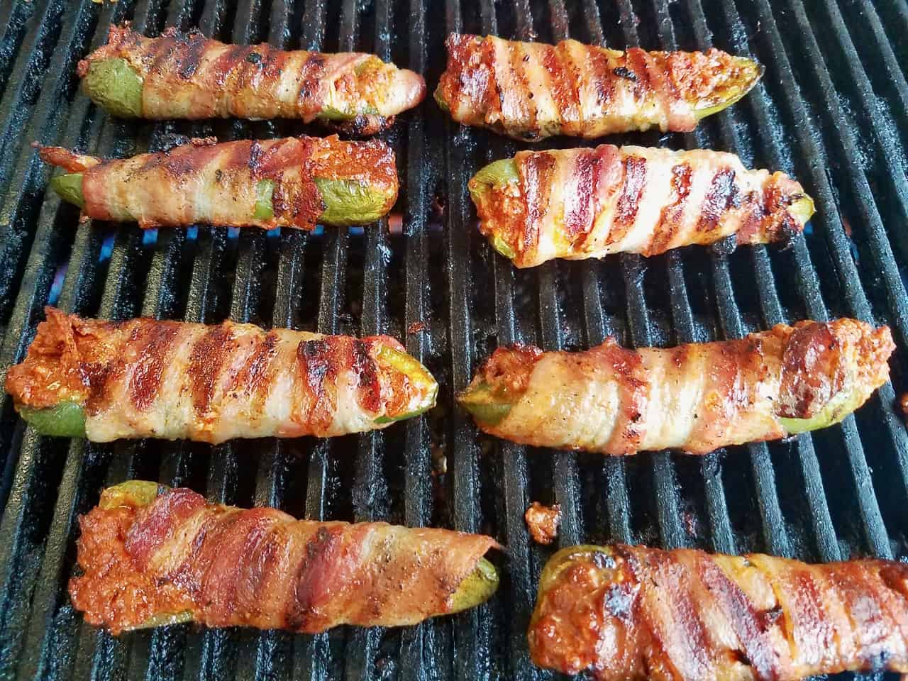 Looking for an easy appetizer recipe for your next barbecue? Stuffed jalapeno poppers are a must! Fresh jalapenos are filled with chorizo and cheese then wrapped with bacon and grilled to crispy perfection. These poppers are seriously addicting, making them a summertime cookout crowd pleaser. | We Three Shanes