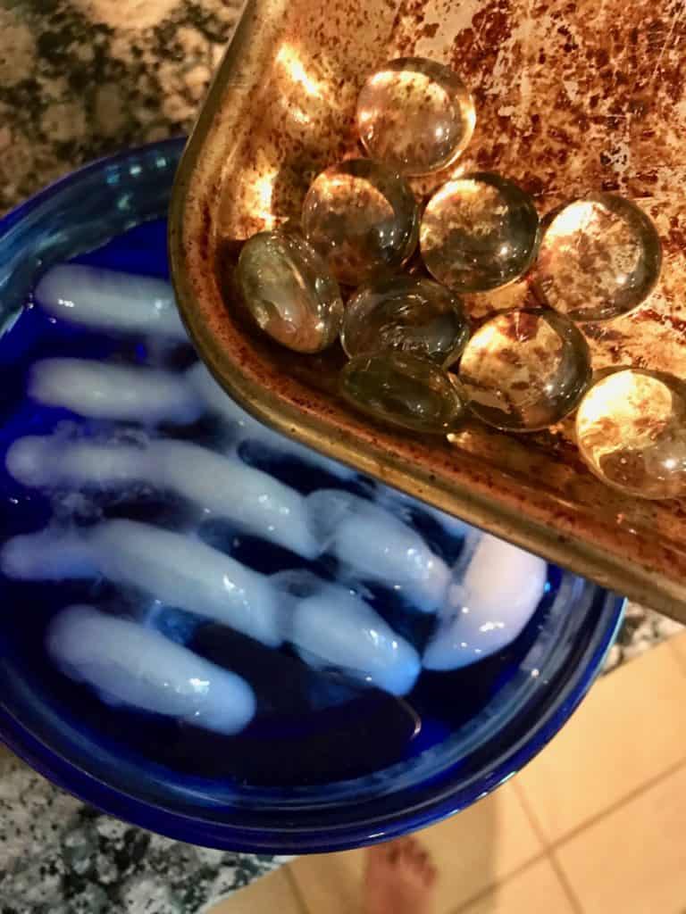 Glass marbles coming out of the oven and being dropped into ice water.