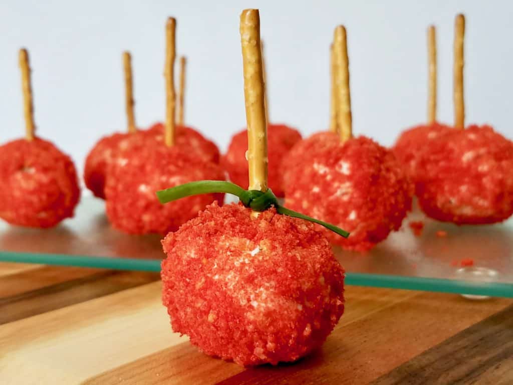 Mini Cheese Ball Bites are the perfect snack on a stick. Flamin' Hot Cheetos add some kick & color to this popular appetizer. Making them a beautiful and tasty treat for your next gathering. | We Three Shanes