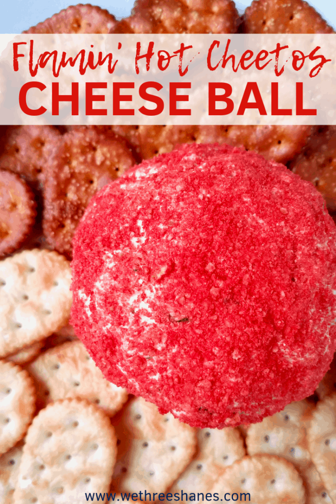 This Flamin' Hot Cheetos Cheese Ball Recipe is bringing some new flavors to the classic appetizer. Taco flavors blend well with the cream cheese filling, while the outer layer of Flamin' Hots adds crunch and kick.  It's perfect for your next party or game day event. | We Three Shanes