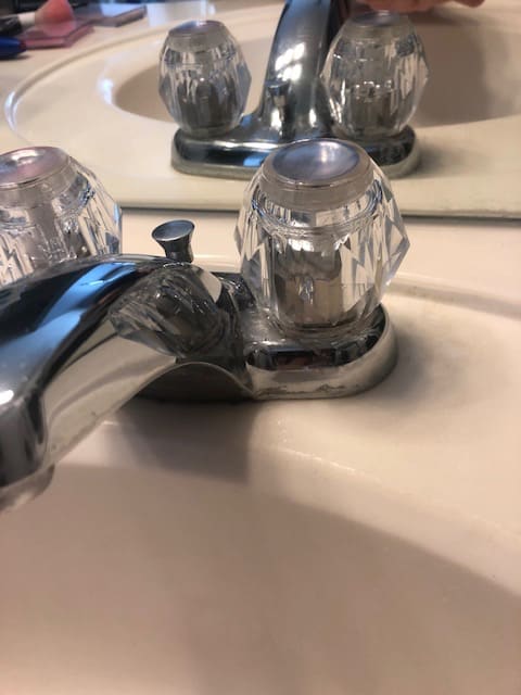 This simple cleaning hack will get rid of stubborn hard water stains from around your faucets and fixtures with ease. Only two household products needed! | We Three Shanes