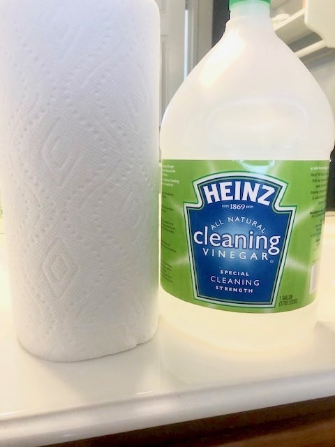 This simple cleaning hack will get rid of stubborn hard water stains from around your faucets and fixtures with ease. Only two household products needed! | We Three Shanes