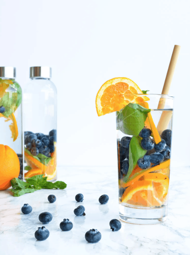 Blueberry Orange Basil Detox Water is a refreshing way to stay hydrated this Summer. Check out this recipe and 16 other Flavored Water Recipes by clicking the link! | We Three Shanes