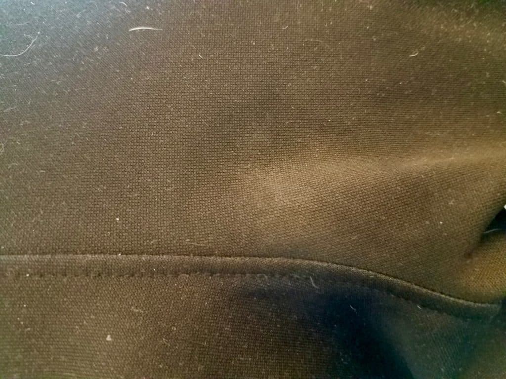 A photo of black fabric that's had silly putty removed.