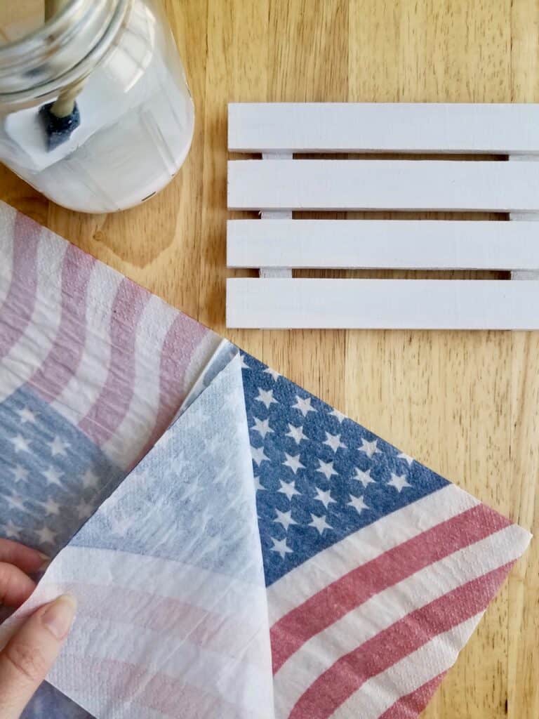 Learn all the steps and tips you need to decoupage with napkins by following this patriotic American flag mini pallet using Dollar Store supplies. | We Three Shanes