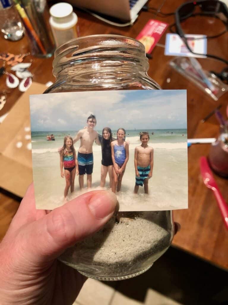 Grab your favorite beach photo, sand, and collected shells and make this DIY Beach Memory Jar to remind you of your fun summer vacation! | We Three Shanes 