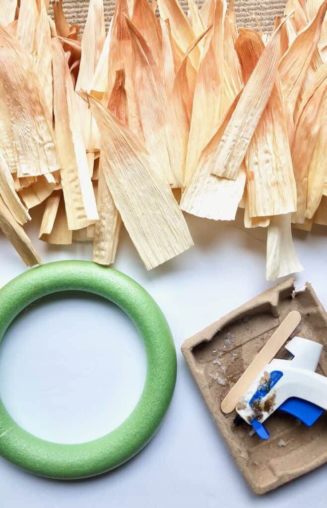 Once corn husks are dyed and dry, it's time to grab your wreath form and glue gun so you can make the wreath.