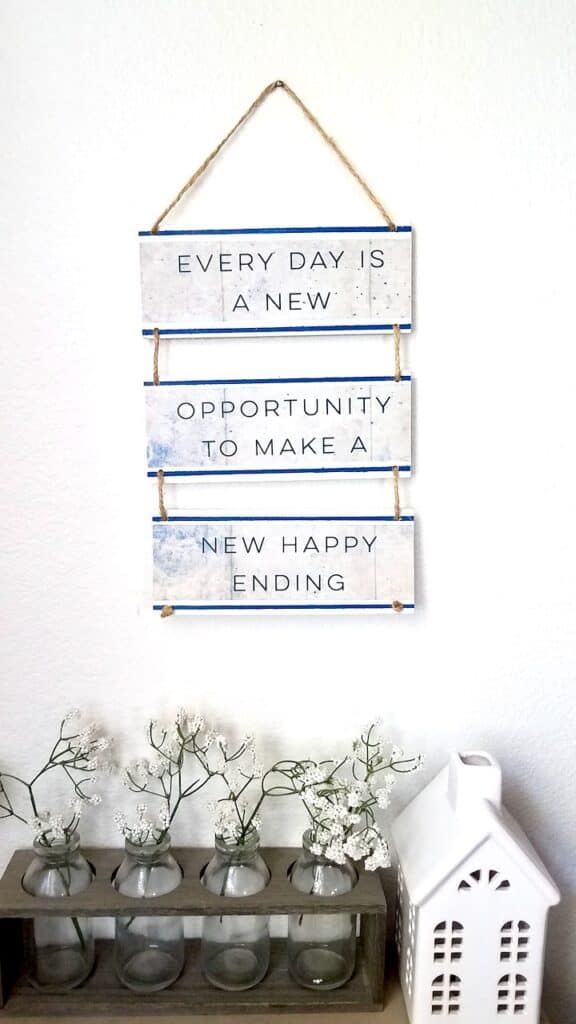 A couple of wood slats and a Dollar Tree Calendar is all you need to make this uplifting quote sign! A super fun Dollar Tree DIY. | We Three Shanes