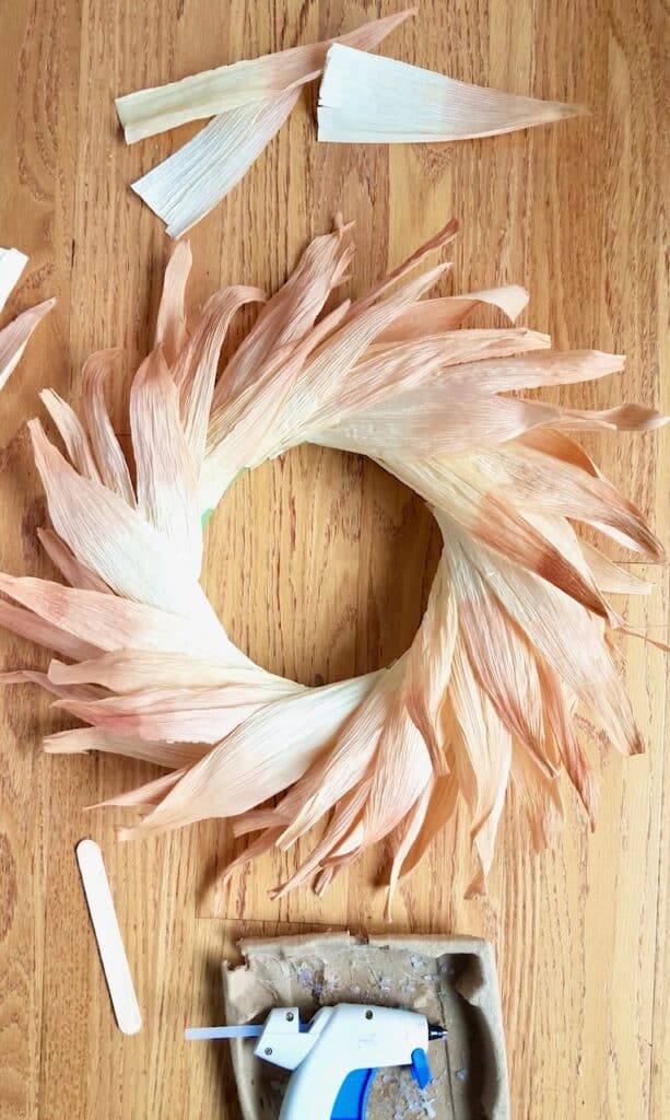 DIY Corn husk wreath with natural dyed pink tips add a bit of fall color and brighten things up. | We Three Shanes