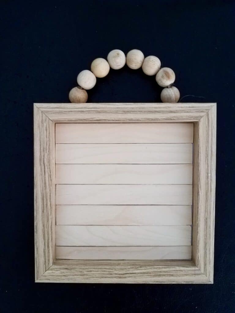 Give a wood bead sign an upgrade with some paint, popsicle sticks, and some dollar store calendars. | We Three Shanes