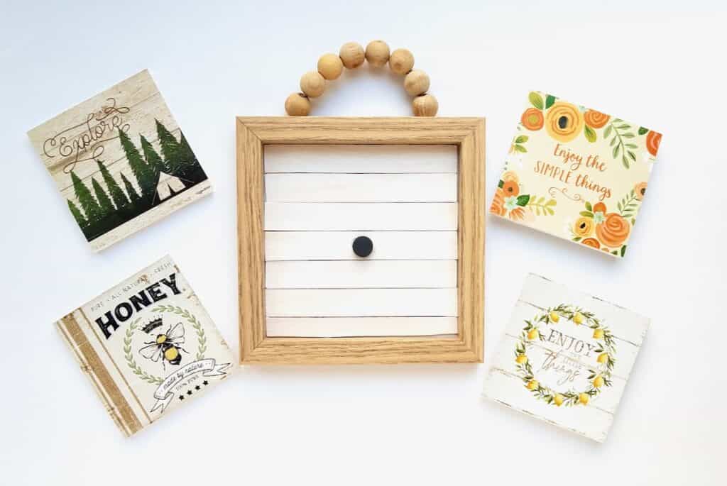 A wood bead sign and some cute calendars from the Dollar Tree are transformed into an interchangeable farmhouse sign you can use all year round. | We Three Shanes