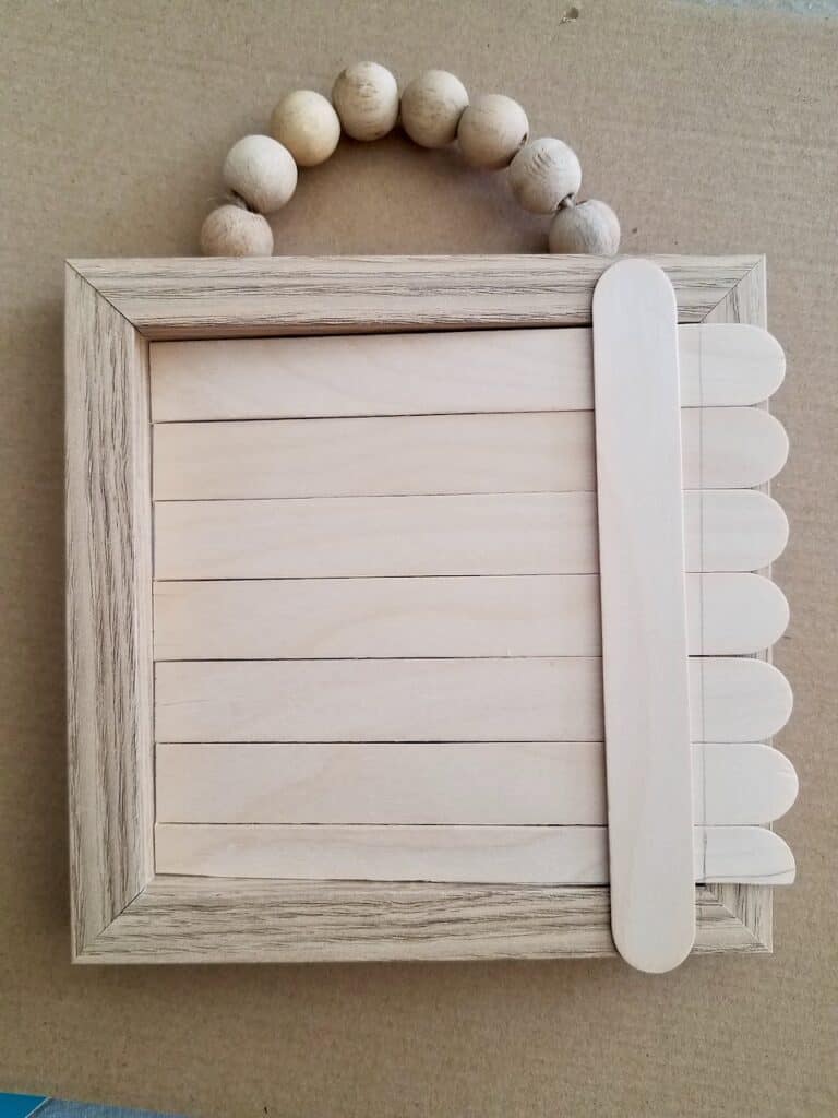 Transform a Dollar Tree Wood Bead Sign into a cute farmhouse frame for all the holidays. | We Three Shanes