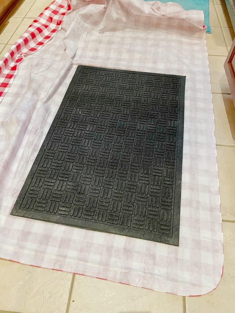 Lay your fabric face down on any clean surface and place the black mat face down on top of the table cloth fabric.