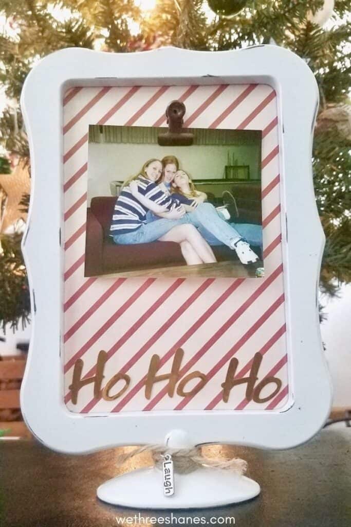 Making this DIY Ho Ho Ho picture frame for your friend this holiday season. It's a fun, budget-friendly Christmas gift. | We Three Shanes