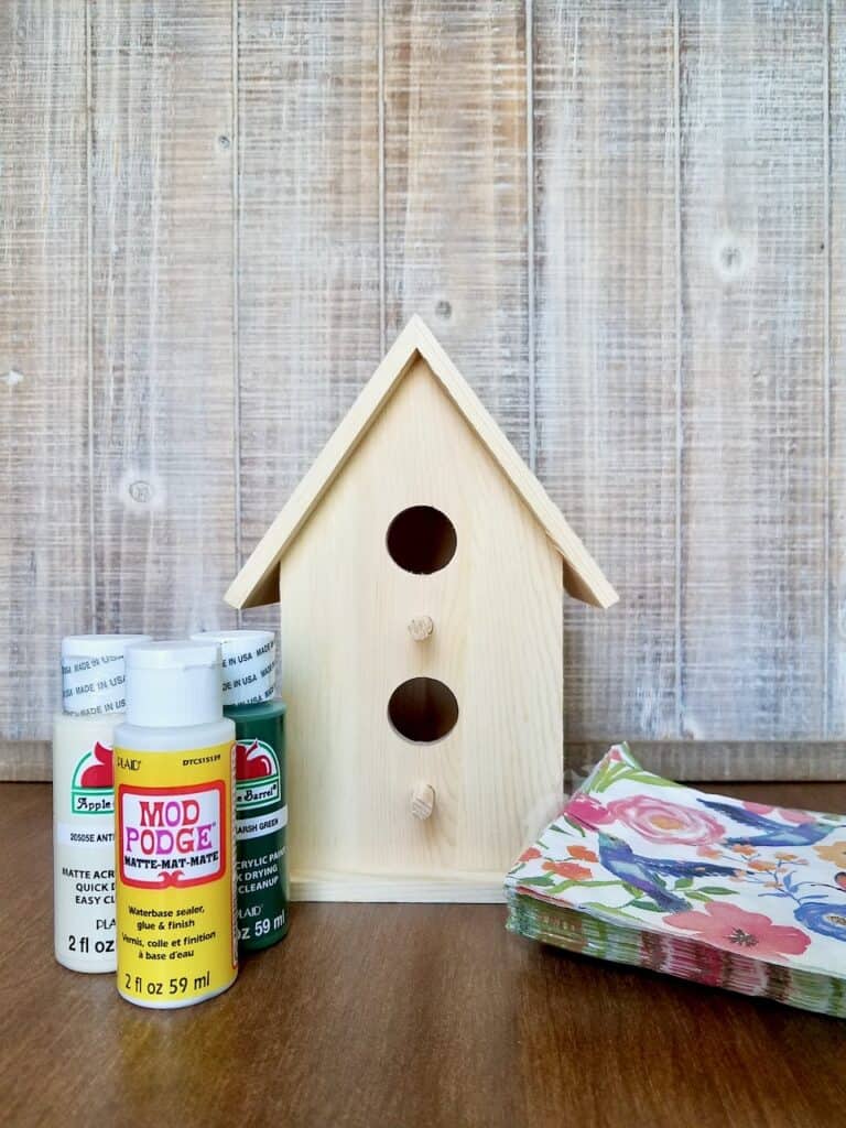 Learn how to decoupage a birdhouse using napkins to create a budget-friendly, shabby chic decor piece for your home or front porch. | We Three Shanes