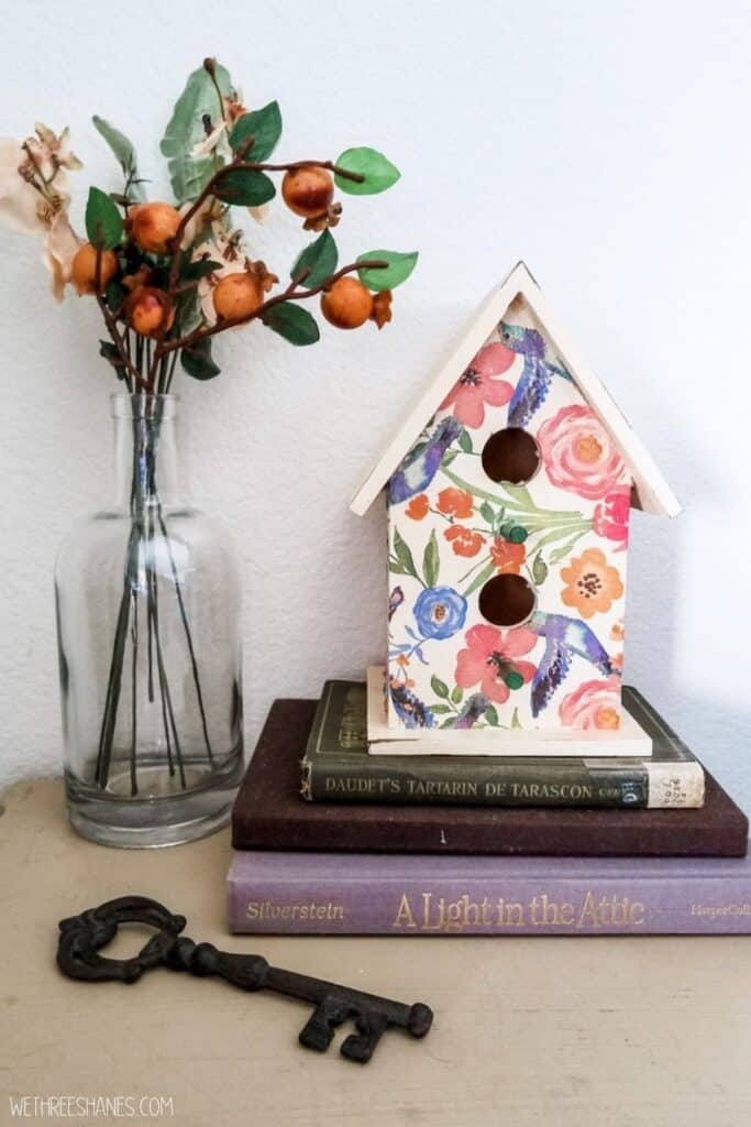 Learn how to decoupage a birdhouse with napkins. A fun spring decor craft. | We Three Shanes