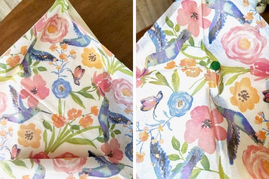 Photo on the left shows a napkin with pink, orange, and blue wild flowers and blue hummingbirds laid over the birdhouse so it can be cut to size. A photo on the right shows the perch from the birdhouse poking through the napkin.