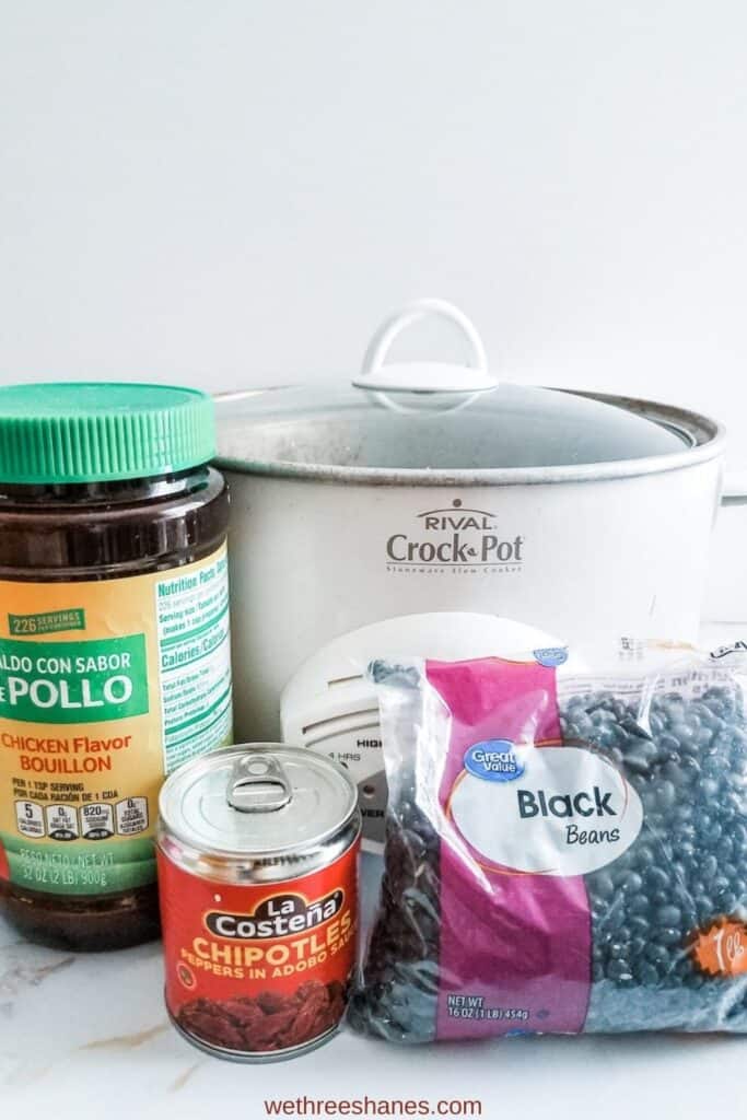 The crockpot, chicken bouillon, canned chipotle peppers, dried black beans pictured here are all you need for delicious, homemade black beans.