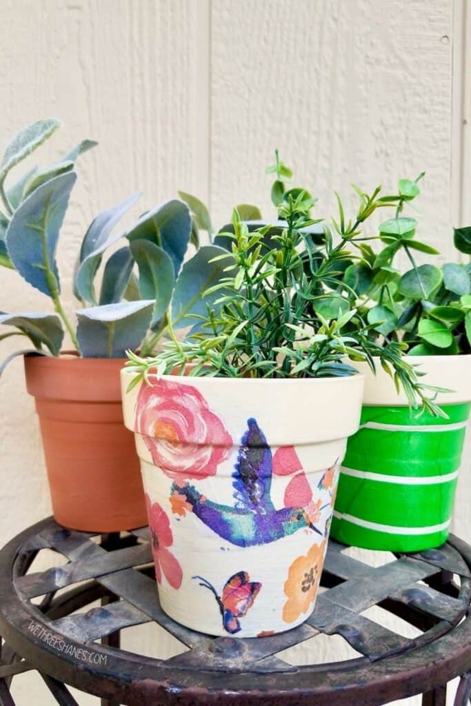 Learn how to decoupage terracotta pots with napkins for some original spring and summer decor. | We Three Shanes