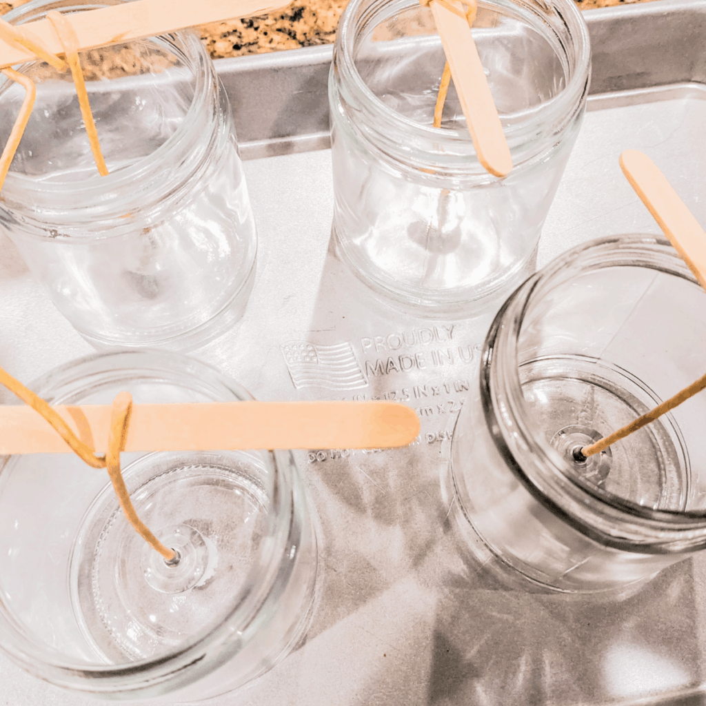 Wicks measured in empty glass jars for candles