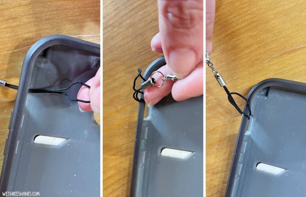 A light gray phone case with the cord for the charm strap being tied around the hole where the on/off button sits when the phone is in.