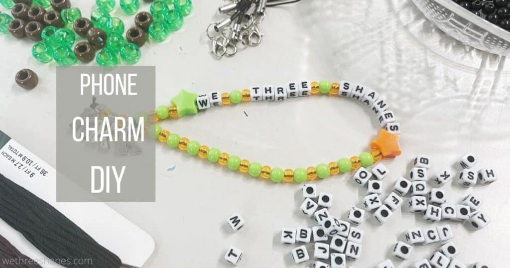DIY phone charm strap is an easy craft that looks great on your phone and helps protect it from drops. Learn how to make one by following this step-by-step tutorial. | We Three Shanes