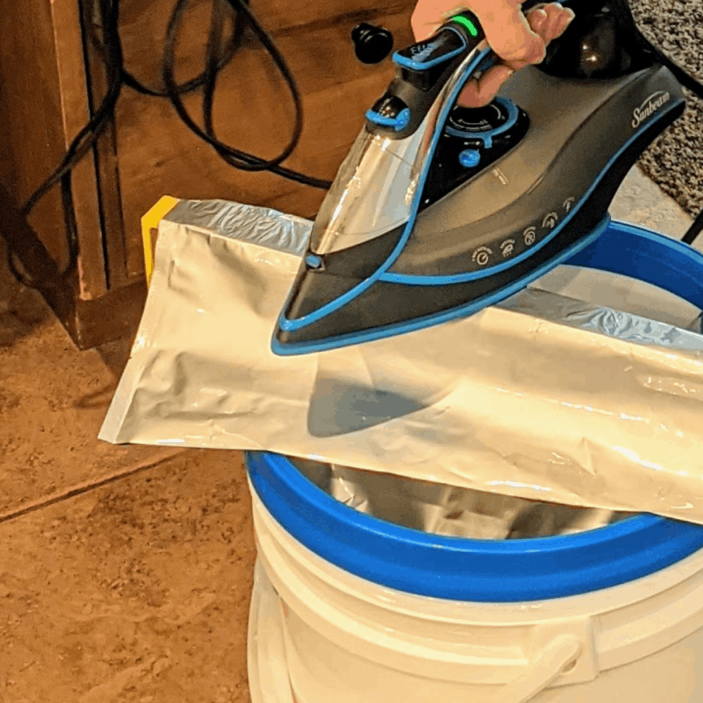 Using a hot iron to seal a mylar bag.