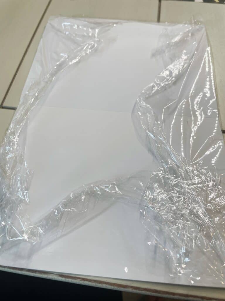 plastic wrap wrapped around a blank greeting card