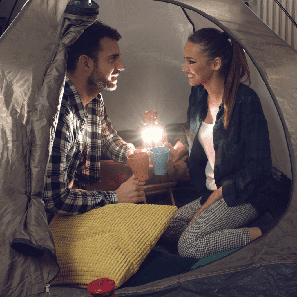 Couple camping indoors for a home date.