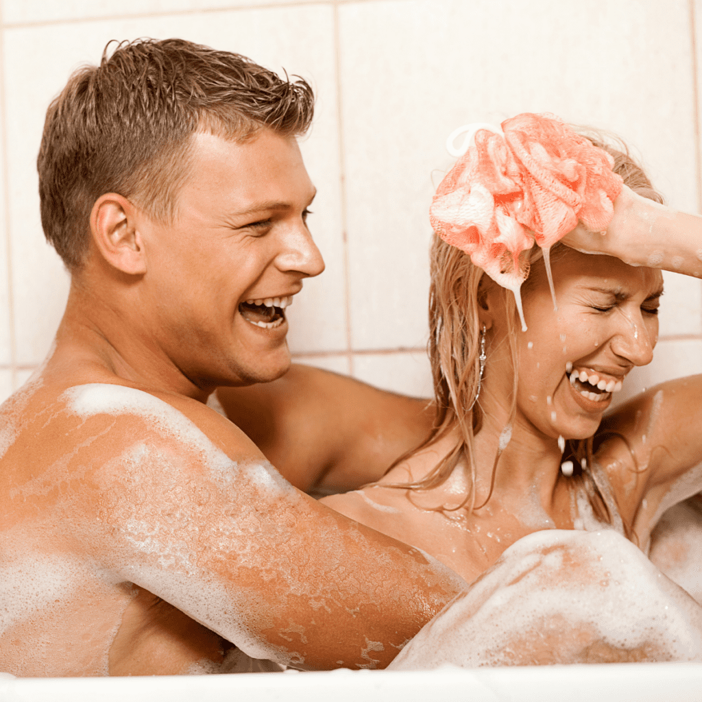 Couple has at home date in the bath.