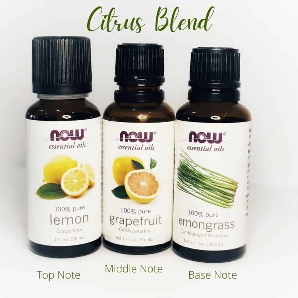 picture of three essential oil bottles. From left to right, lemon, grapefruit and lemongrass. Text on top says Citrus Blend and the text on the bottom reads from left to right Top note, middle note and base note | WeThreeShanes