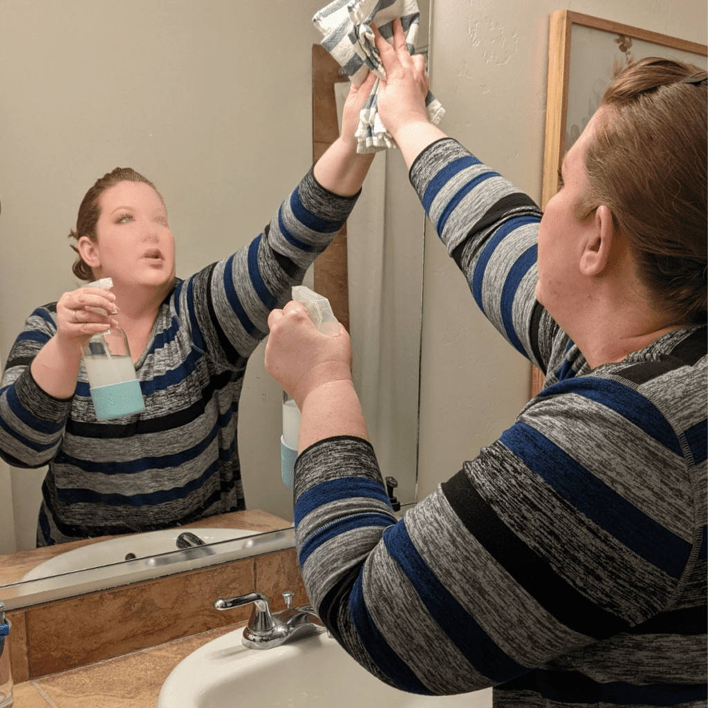 Cleaning a  bathroom mirror with DIY glass cleaner