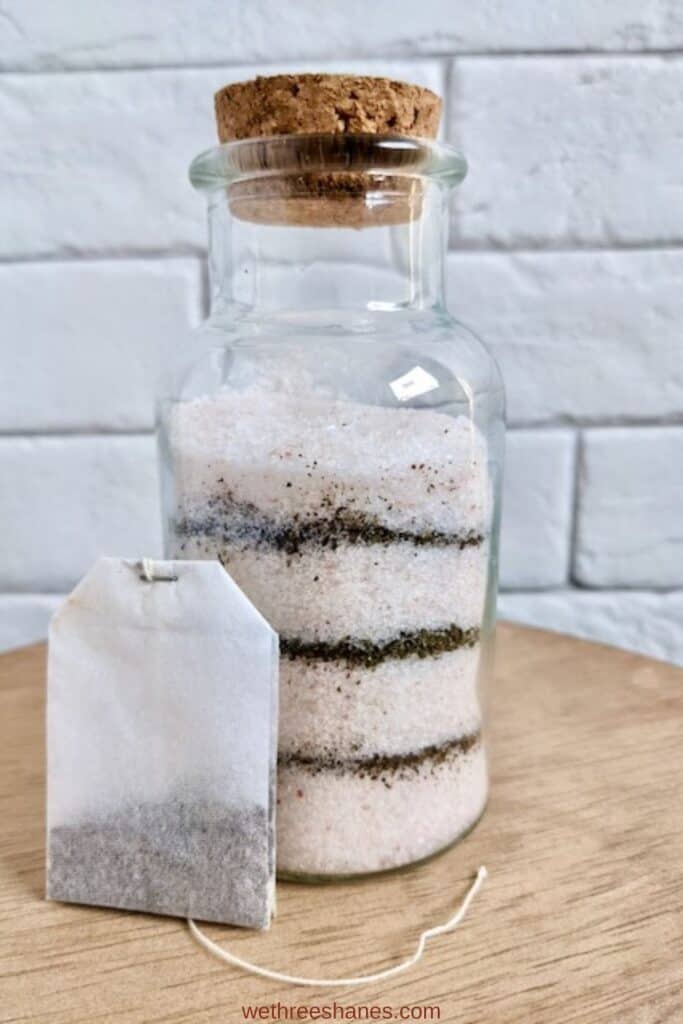Jar with a cork top filled with green tea and epsom salt homemade foot soak.