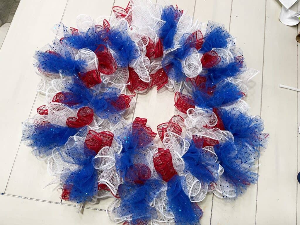 Finished red, white and blue mesh clusters covering entire wreath form