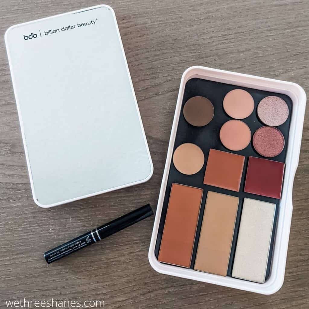 Billion Dollar Beauty box brings a low waste, magnetic makeup box for less. The box holds up to nine pieces of makeup. This one has 4 eyeshadows, a brow pomade, concealer, bronzer, blush, and two lip balms.