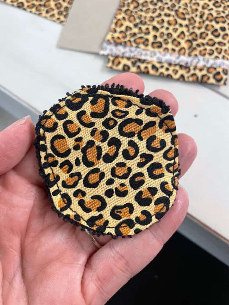 a picture of a reusable cotton round made from cheetah fabric 