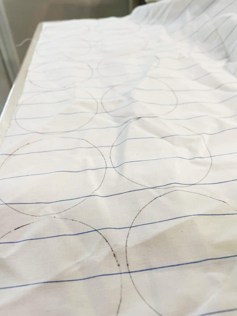 A large piece of fabric with several round circles drawn on it