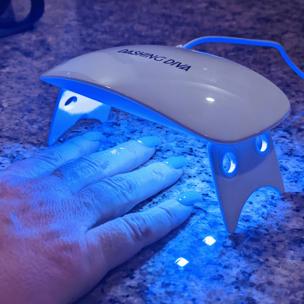 Dashing Diva Glaze nails under the mini LED lamp.