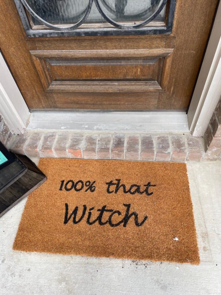 a doormat that says, 100% That Witch